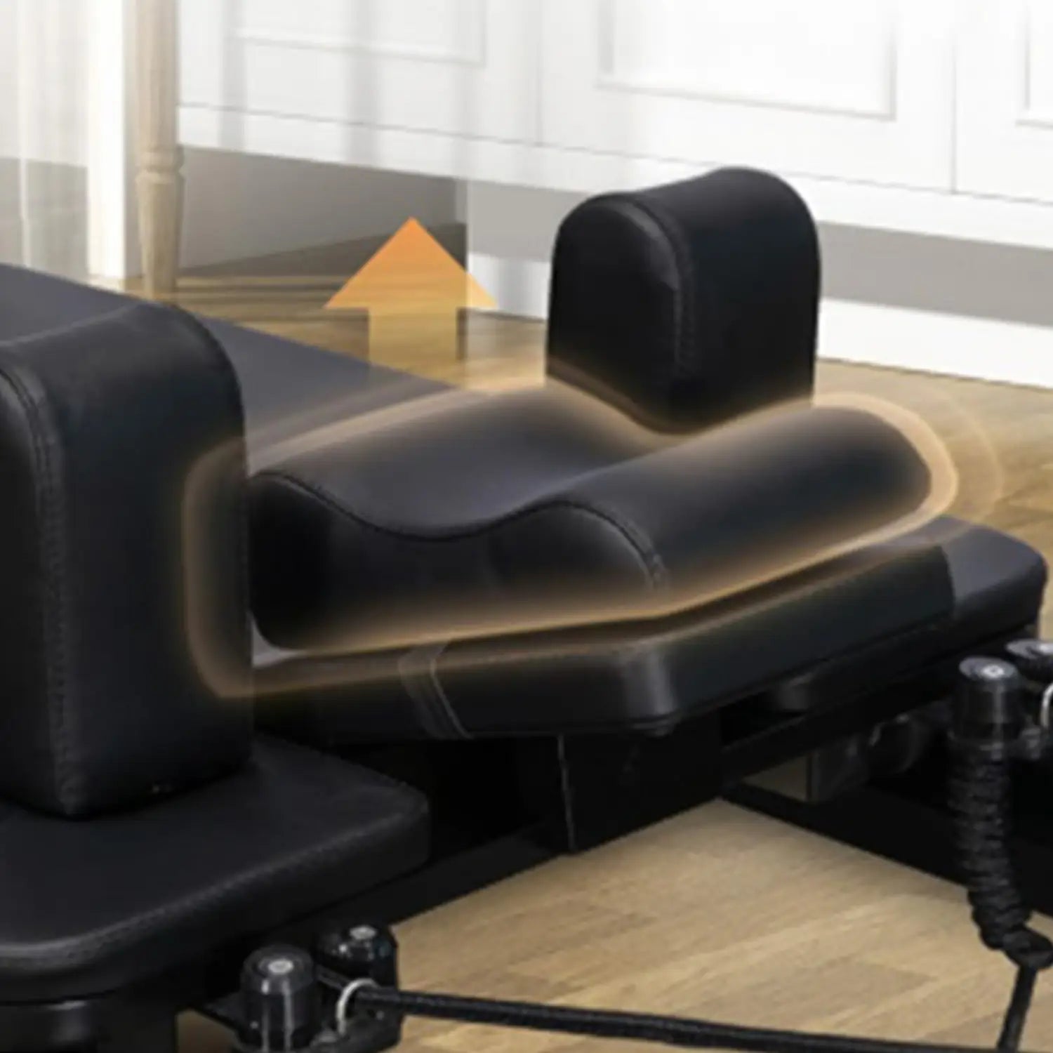 black leather-like neck support pillow with contoured design and headrest for ergonomic support on pilates reformer seat