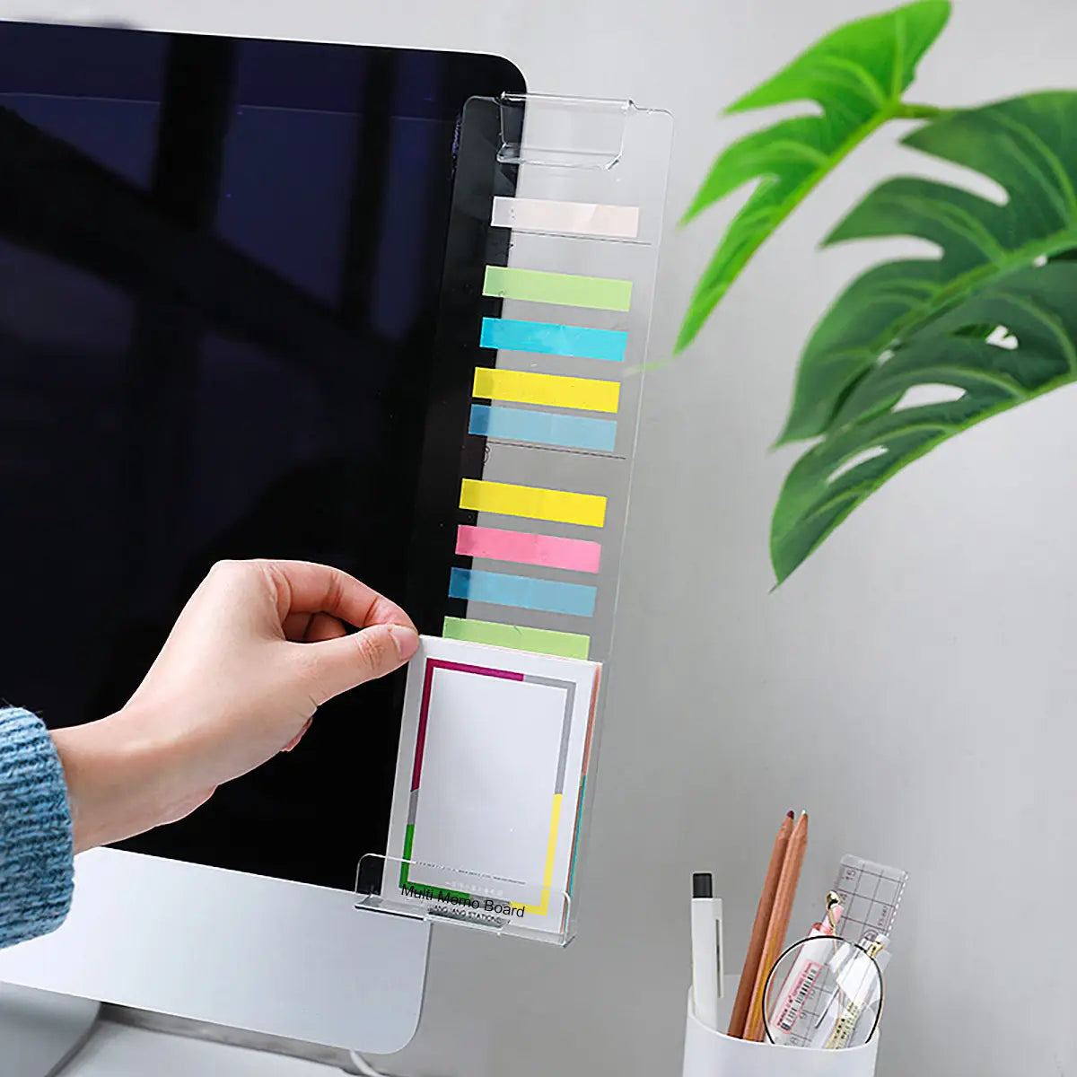 clear acrylic monitor memo board with phone holder featuring a desk organizer with colorful sticky notes and a white notepad holder