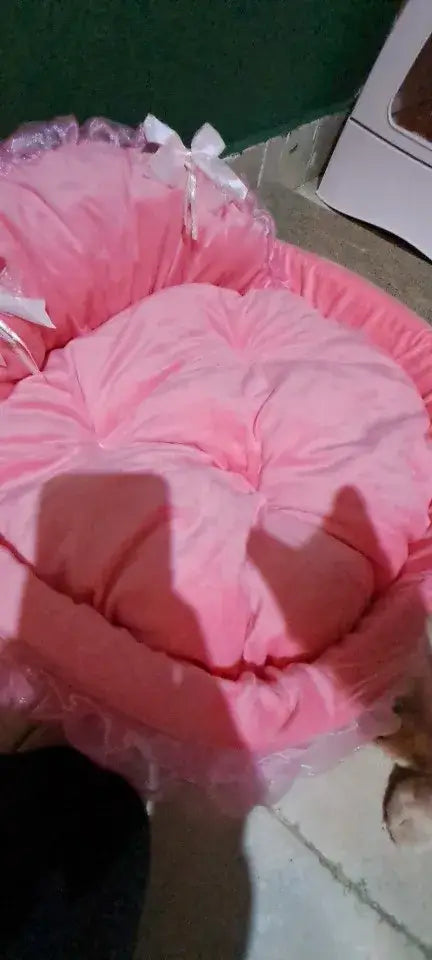 Princess pink lace pet bed for dogs and cats featuring a pink heart-shaped design with ruffled edges and white bows.