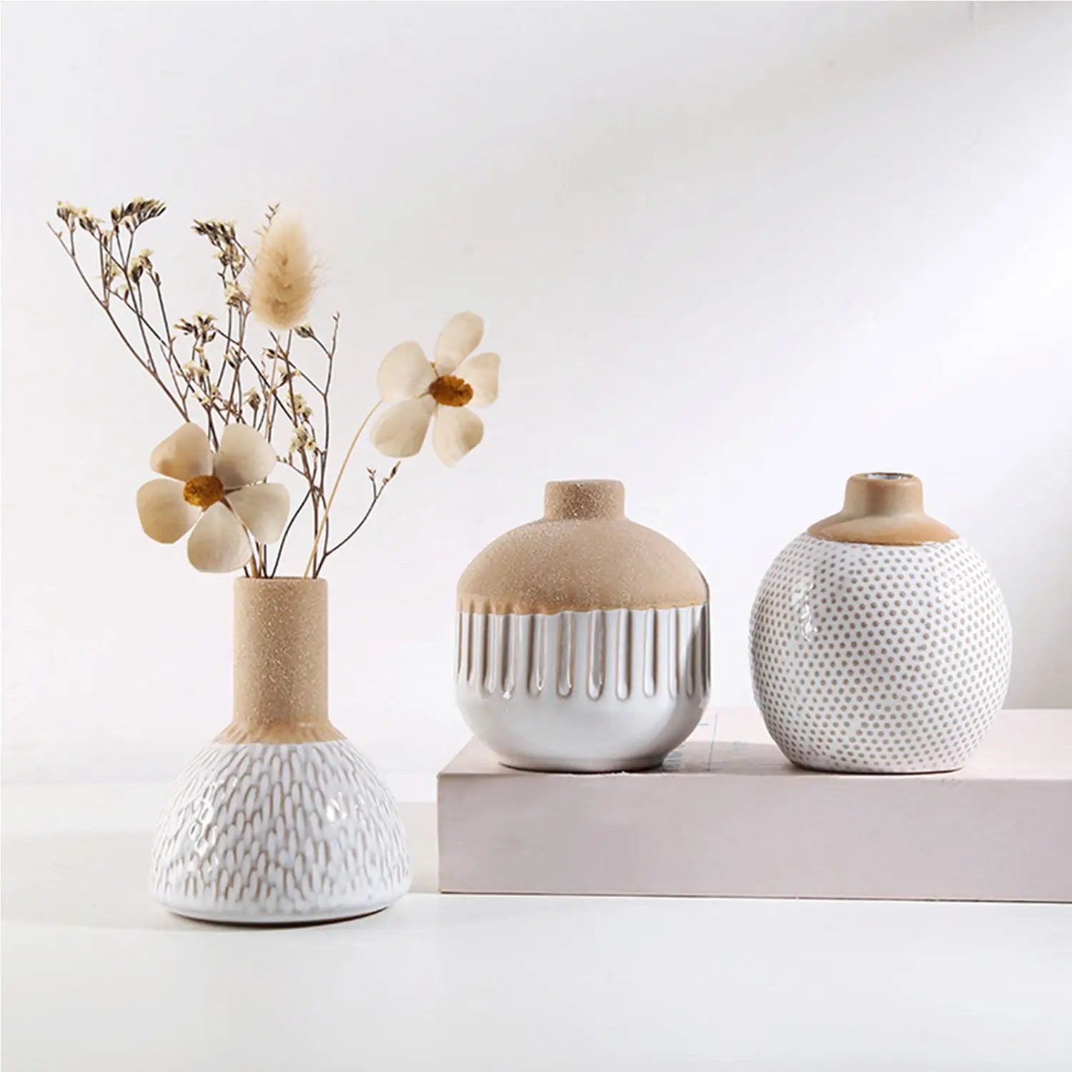 three ceramic flower vases with textured white and beige surfaces featuring vertical ridges and dotted patterns ideal for boho tabletop decor