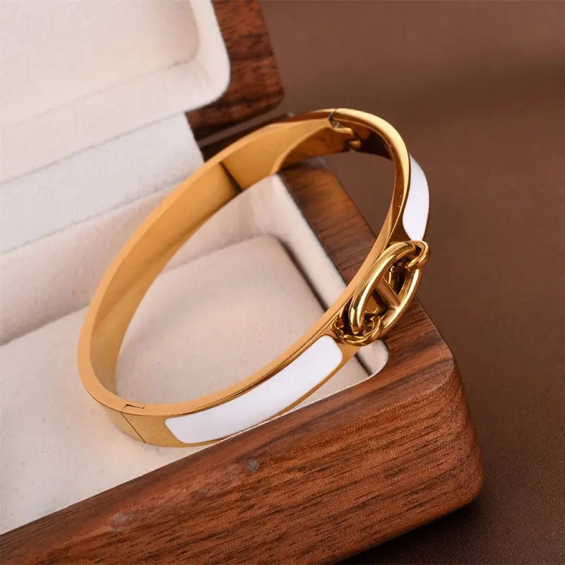 Women h bangle gold enamel minimalist bracelet featuring a gold-tone hinged bangle with a white enamel stripe and interlocking chain clasp as a fashion bracelet minimalist accessory.
