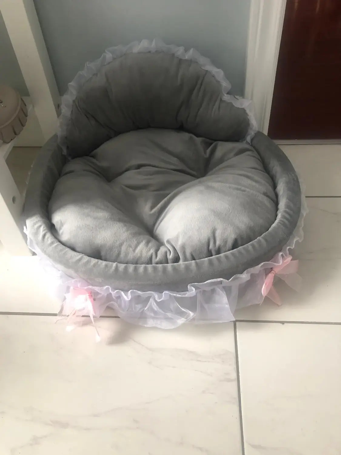 Gray plush pet bed with ruffled white lace trim and pink ribbon accents designed for dogs and cats in the princess pink lace pet bed collection.