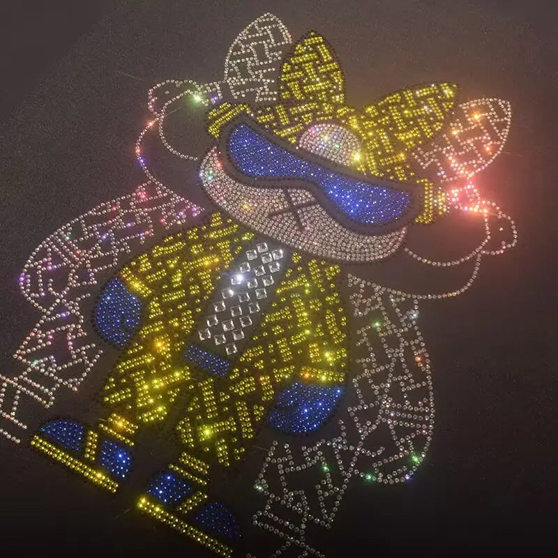 Men rhinestone devil bear graphic tee featuring a sparkling rhinestone-embellished yellow and blue cartoon character design on dark fabric.