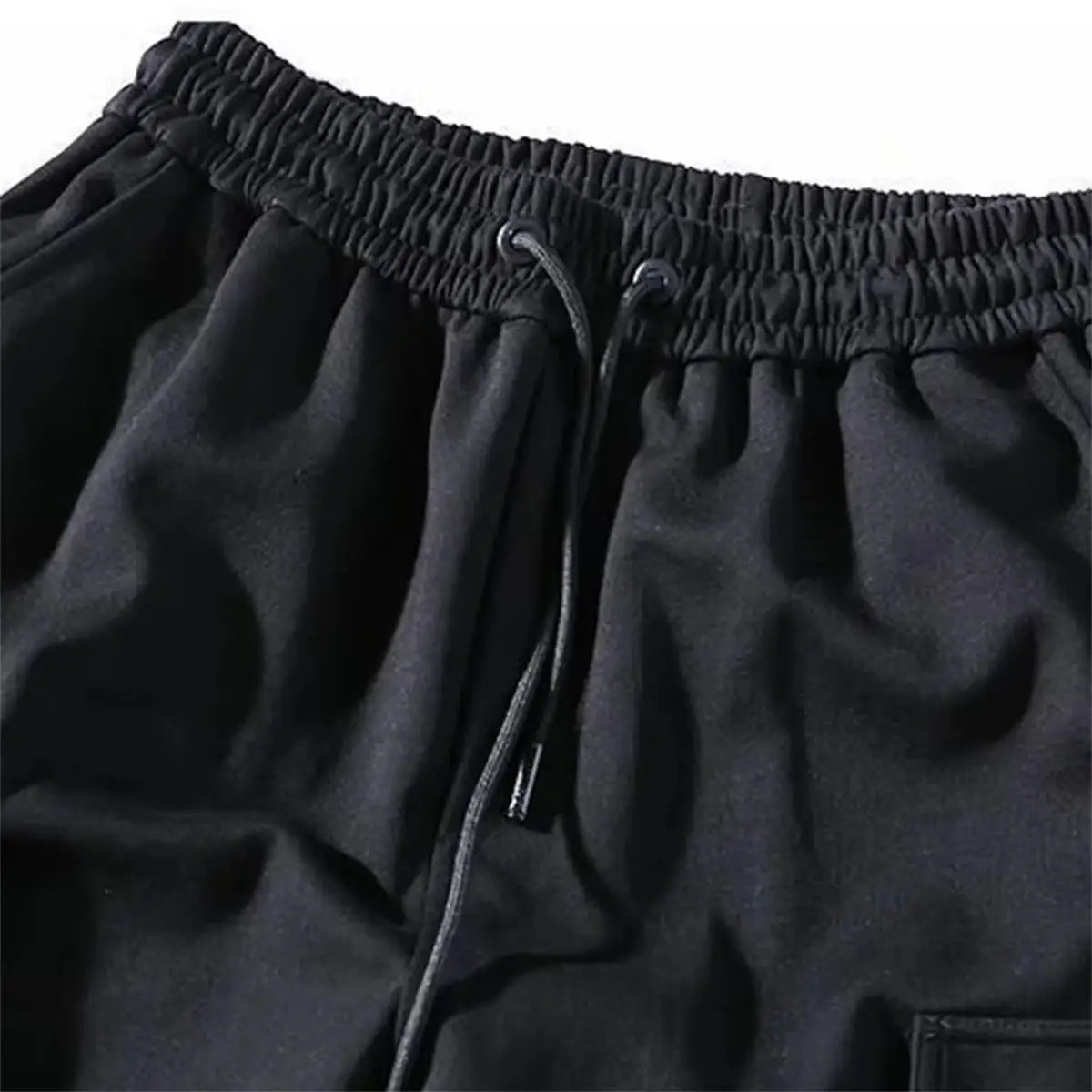 Men black cargo jogger pants featuring an elastic waistband with drawstring and soft textured fabric for comfort and multiple pockets for utility.