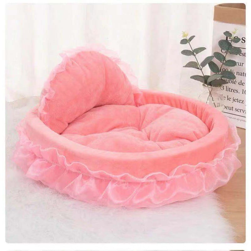 Princess pink lace pet bed for dogs and cats featuring a pink plush material with ruffled edges and a matching cushion.