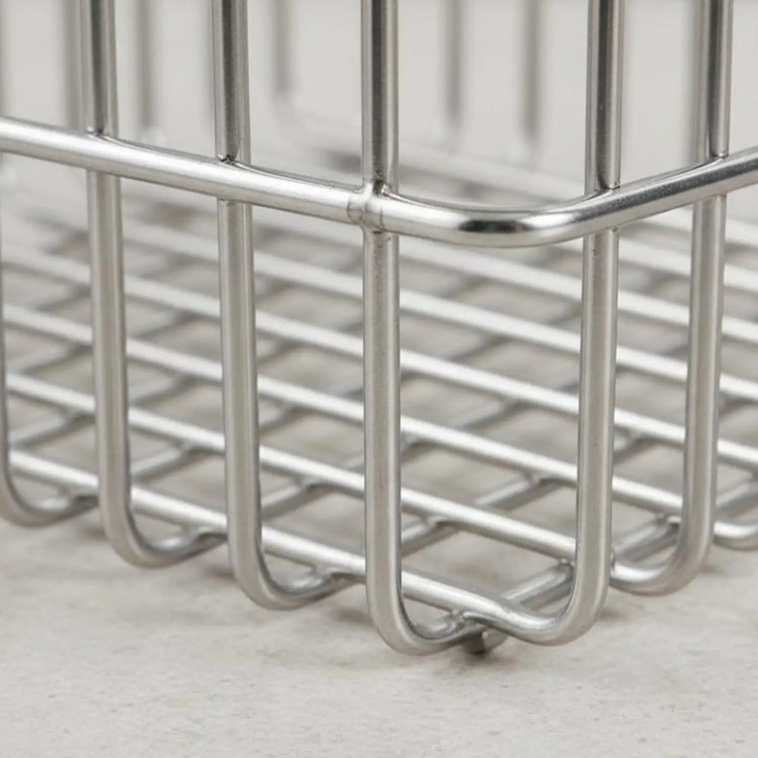 Stainless steel wire storage basket organizer with a sleek rectangular design and rounded edges in silver metal.