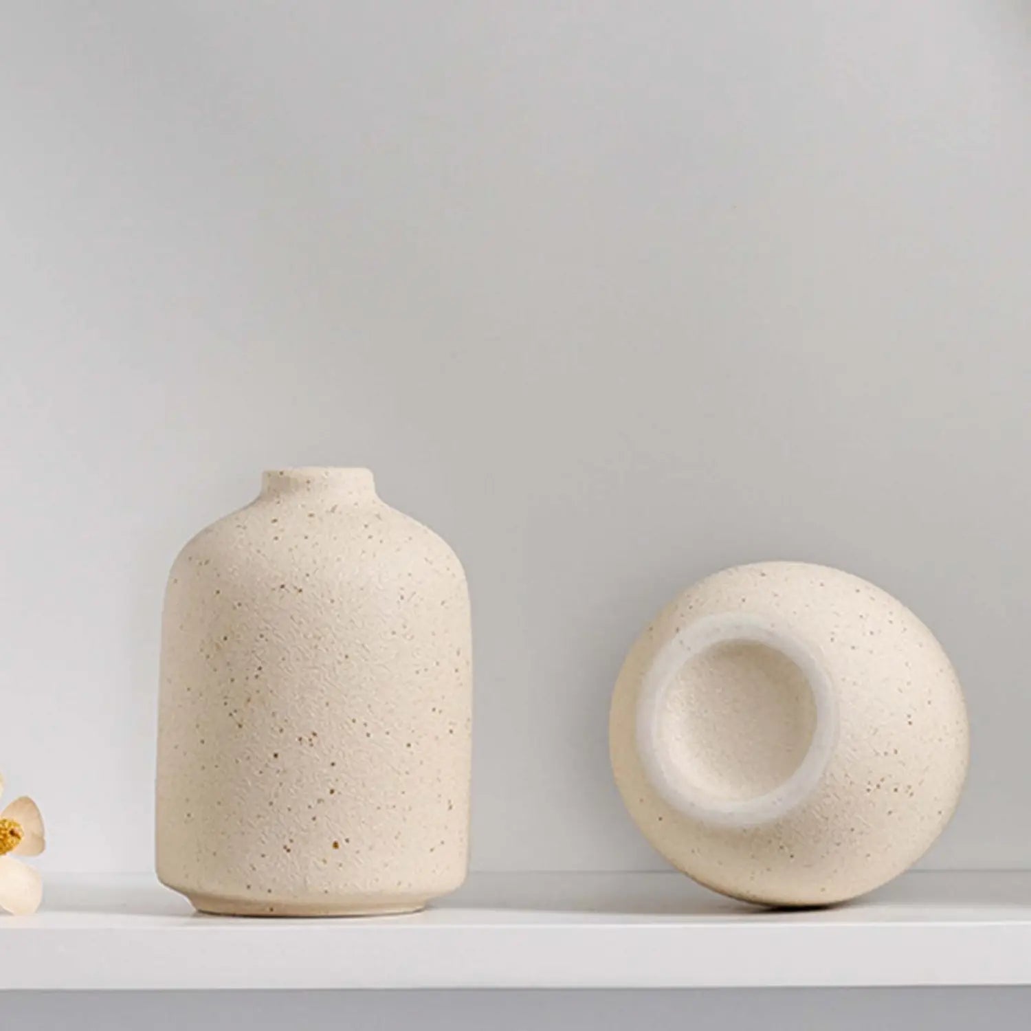 cream-colored speckled ceramic flower vase with a matte finish and minimalist design ideal for boho tabletop decor