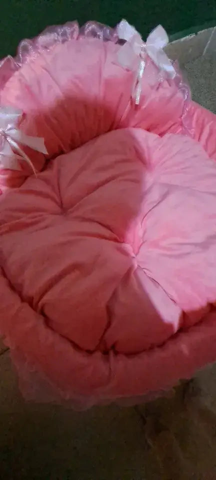 Princess pink lace pet bed for dogs and cats featuring a pink heart-shaped design with ruffled edges and white bows.