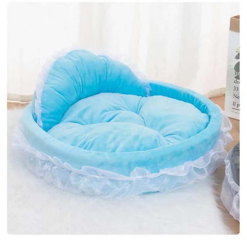 A soft light blue plush pet bed with ruffled white lace trim and quilted cushioning designed for dogs and cats in the princess pink lace pet bed collection.