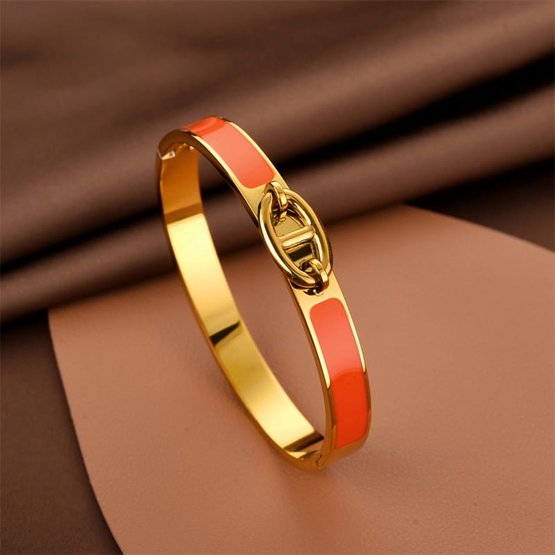 Women h bangle gold enamel minimalist bracelet featuring a gold-tone bangle with vibrant coral enamel panels and a signature interlocking h clasp, ideal as a bangle fashion bracelet.