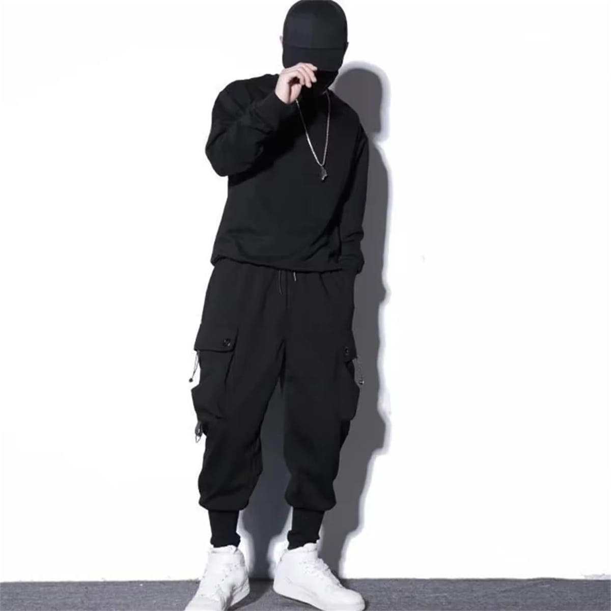 men black cargo jogger pants featuring multiple side pockets and a drawstring waistband for a comfortable fit.