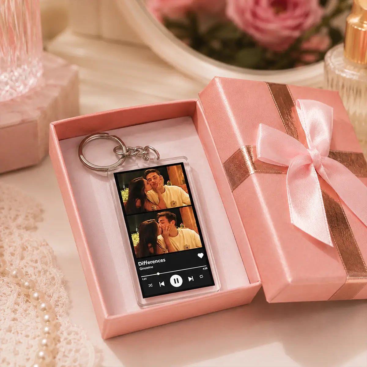 A clear acrylic custom Spotify music player keychain featuring a personalized music player design with the song Differences by Giovanni and two romantic scenes from the movie.