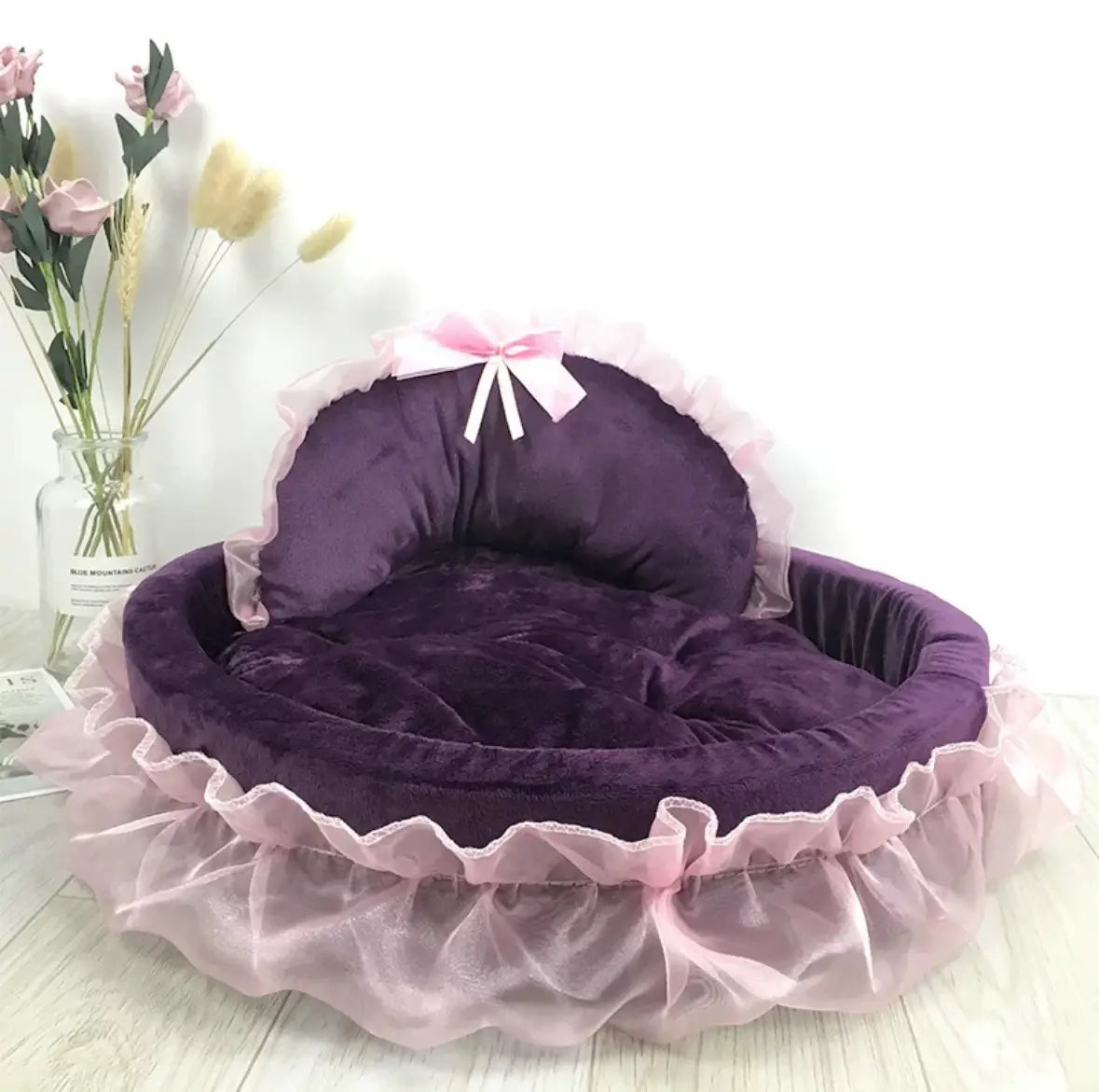 Purple velvet pet bed with pink ruffled trim and matching bow designed for dogs and cats in the Princess Pink Lace collection.