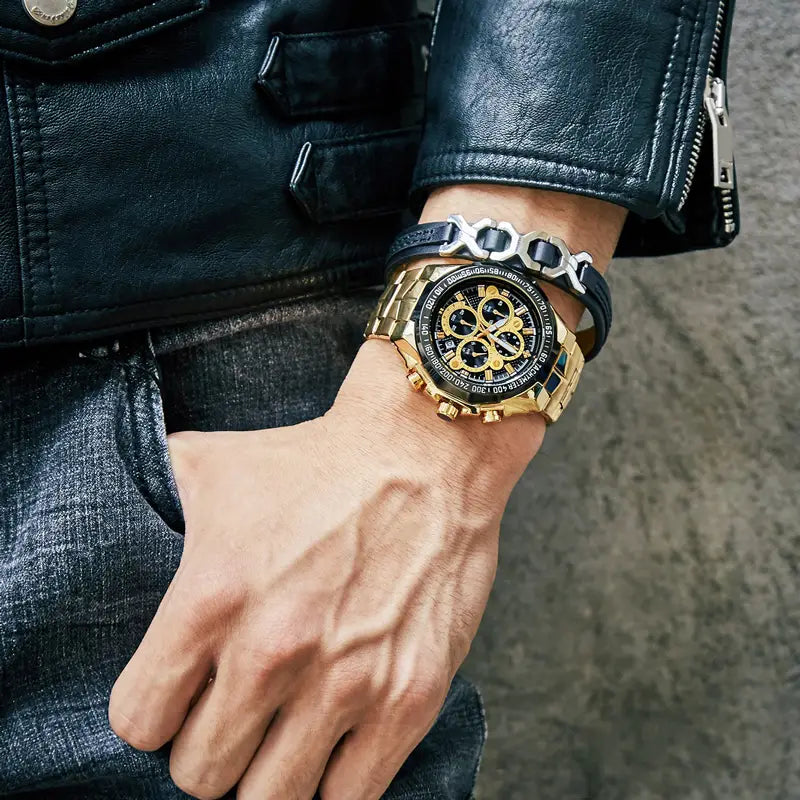 Gold chronograph watch for men featuring a black dial with multiple subdials, a gold-toned stainless steel case, and a silver-and-black metallic link bracelet.