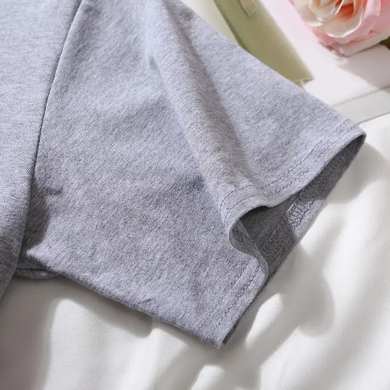 Gray heathered cotton sleeve with a neatly stitched hem on a women solid short sleeve crop top casual t-shirt.