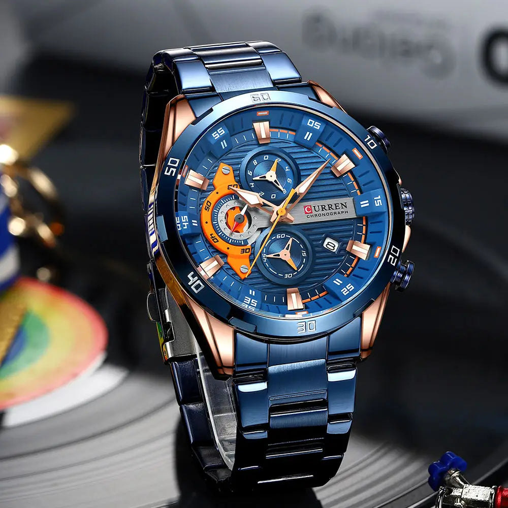 Curren men black green chronograph stainless steel watch with a blue and rose gold multi-layered dial featuring orange accents.