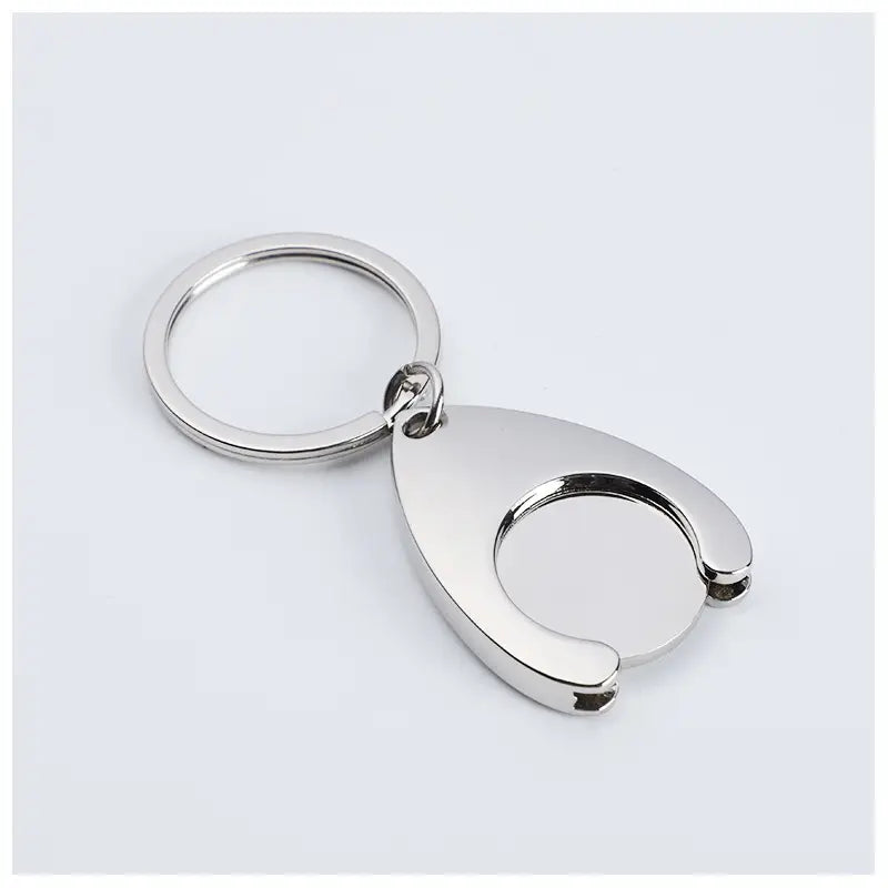 Custom engraved metal keychain featuring a silver metallic sleek teardrop-shaped pendant with an open circular cutout.