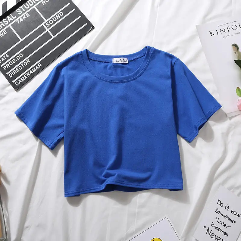 A vibrant royal blue women solid short sleeve crop top casual t-shirt made of smooth cotton fabric with short sleeves and a round neckline.
