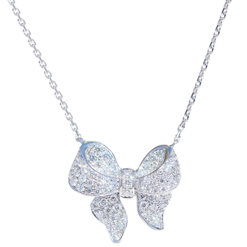 A silver bowknot zircon necklace pendant sparkling with numerous clear faceted stones.