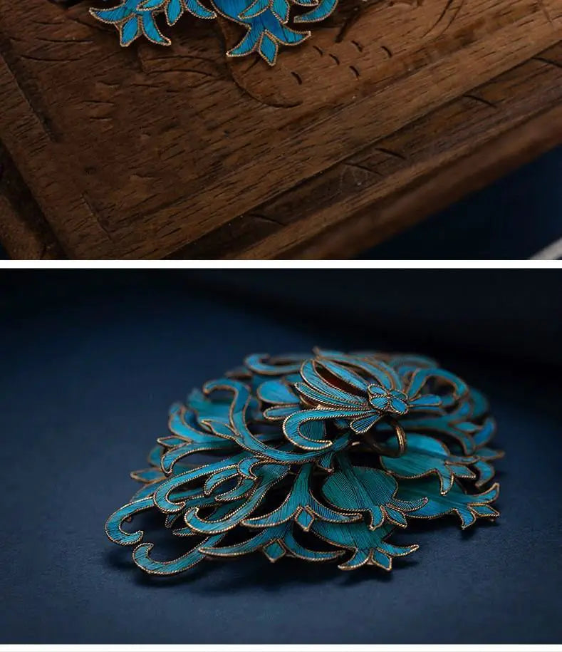 A delicate turquoise enamel filigree brooch with intricate gold-toned floral detailing from the palace jewelry collection.