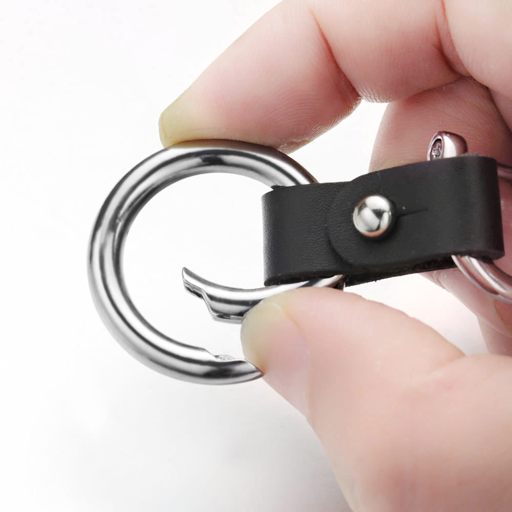 Black leather car keychain featuring silver hardware with a metal ring and hook.