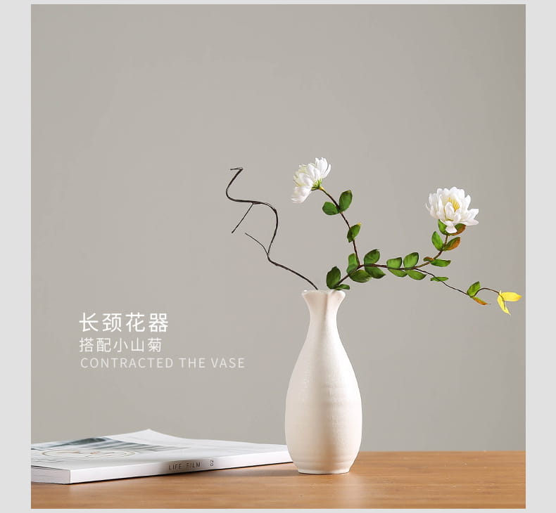 A sleek modern white ceramic vase with a slender neck and gently flared base for floral decor.