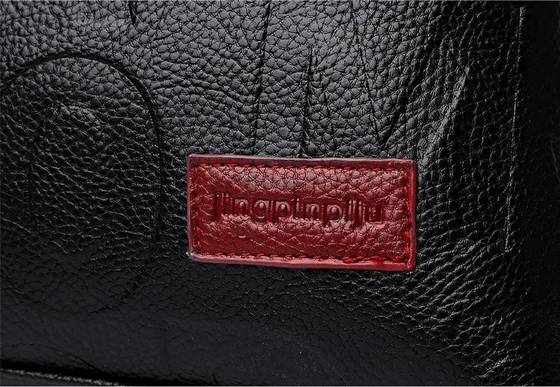 black crossbody handbag in pu leather with textured black material and a red rectangular brand patch embossed with jingpinpiliu featuring style1 style2 style1 design.