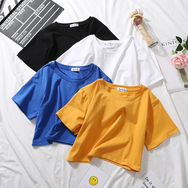 A set of four women solid short sleeve crop tops in black white blue and yellow perfect for casual wear.