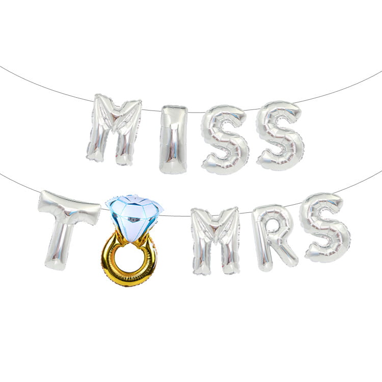 Silver foil balloon banner set spelling miss to mrs with a central gold ring and blue diamond-shaped balloon for bride to be celebrations.