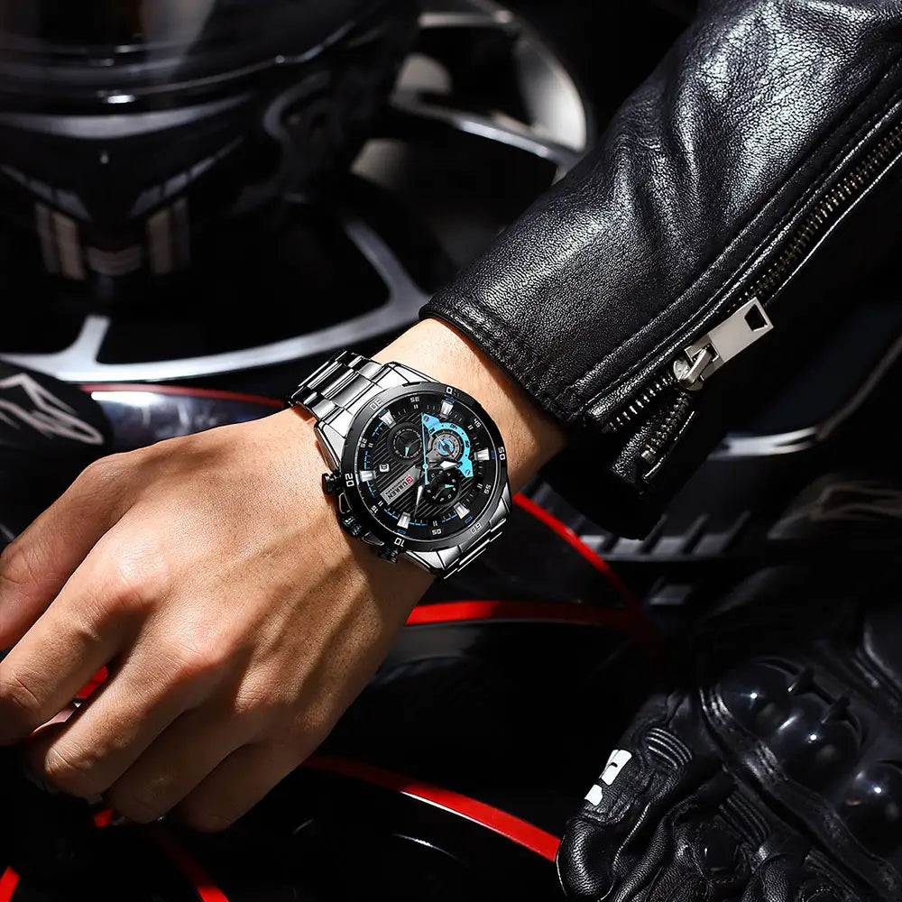 Curren men black and blue chronograph stainless steel watch with a green accent worn on a wrist.
