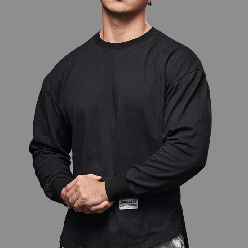 Black men long sleeve cotton t shirt with crew neck and small rectangular label on the lower left side featuring a curved hem design.