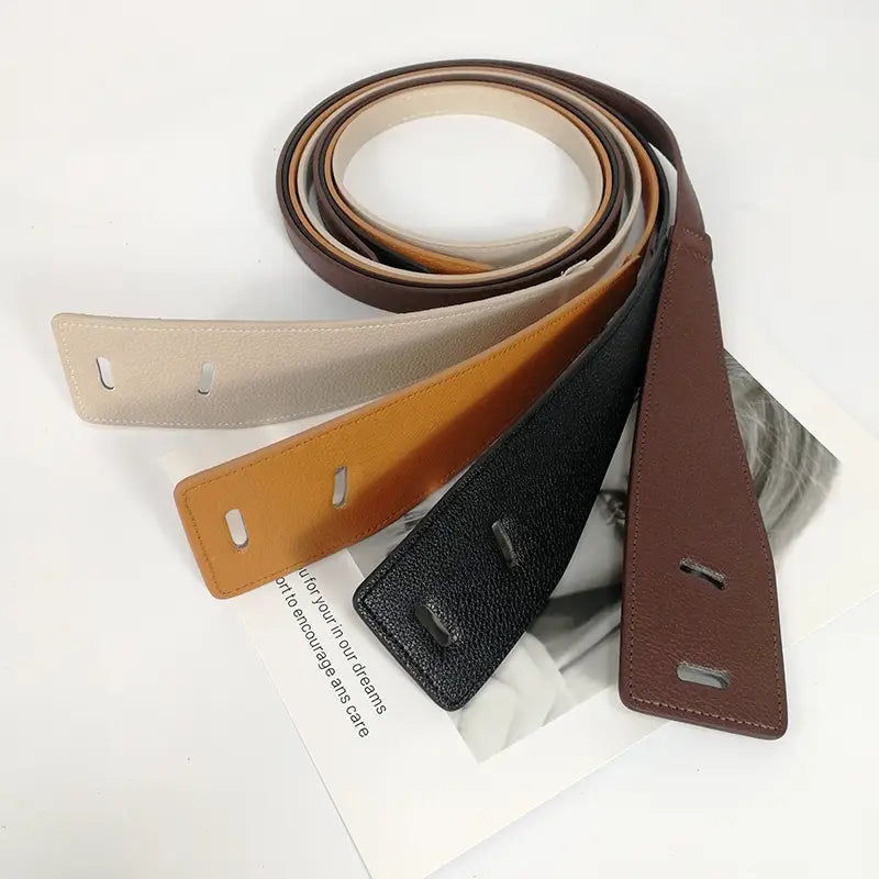 A collection of four slim flat textured pu leather belts in beige tan black and brown with metal buckle hardware for women.