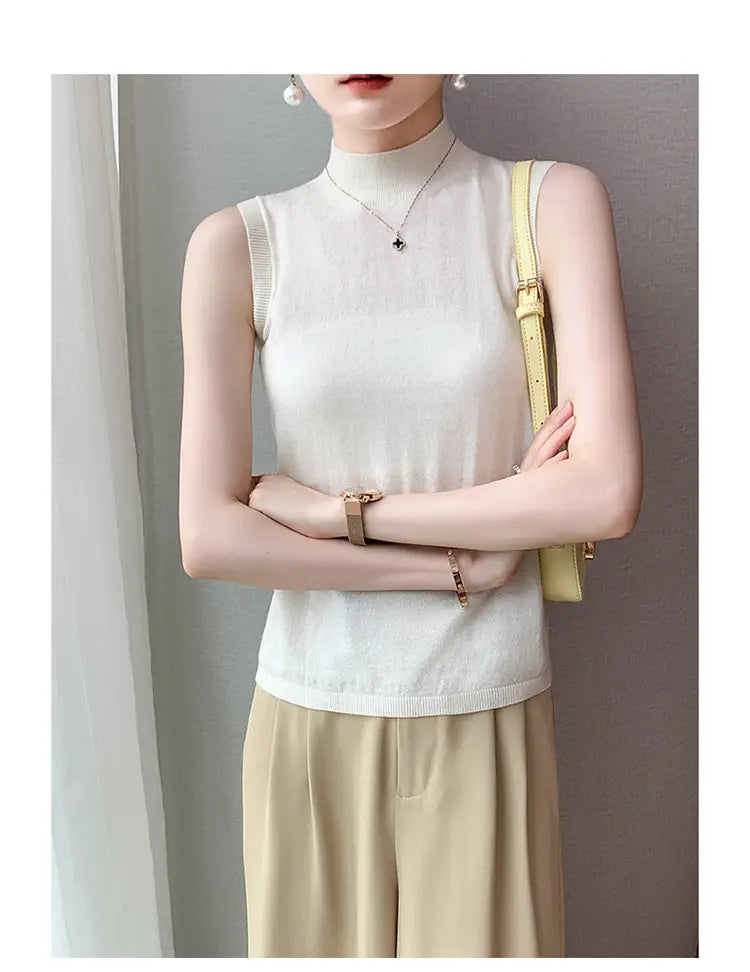 A delicate off-white wool turtleneck sleeveless sweater vest with a soft breathable knit texture and subtle ribbed detailing along the neckline and hem.