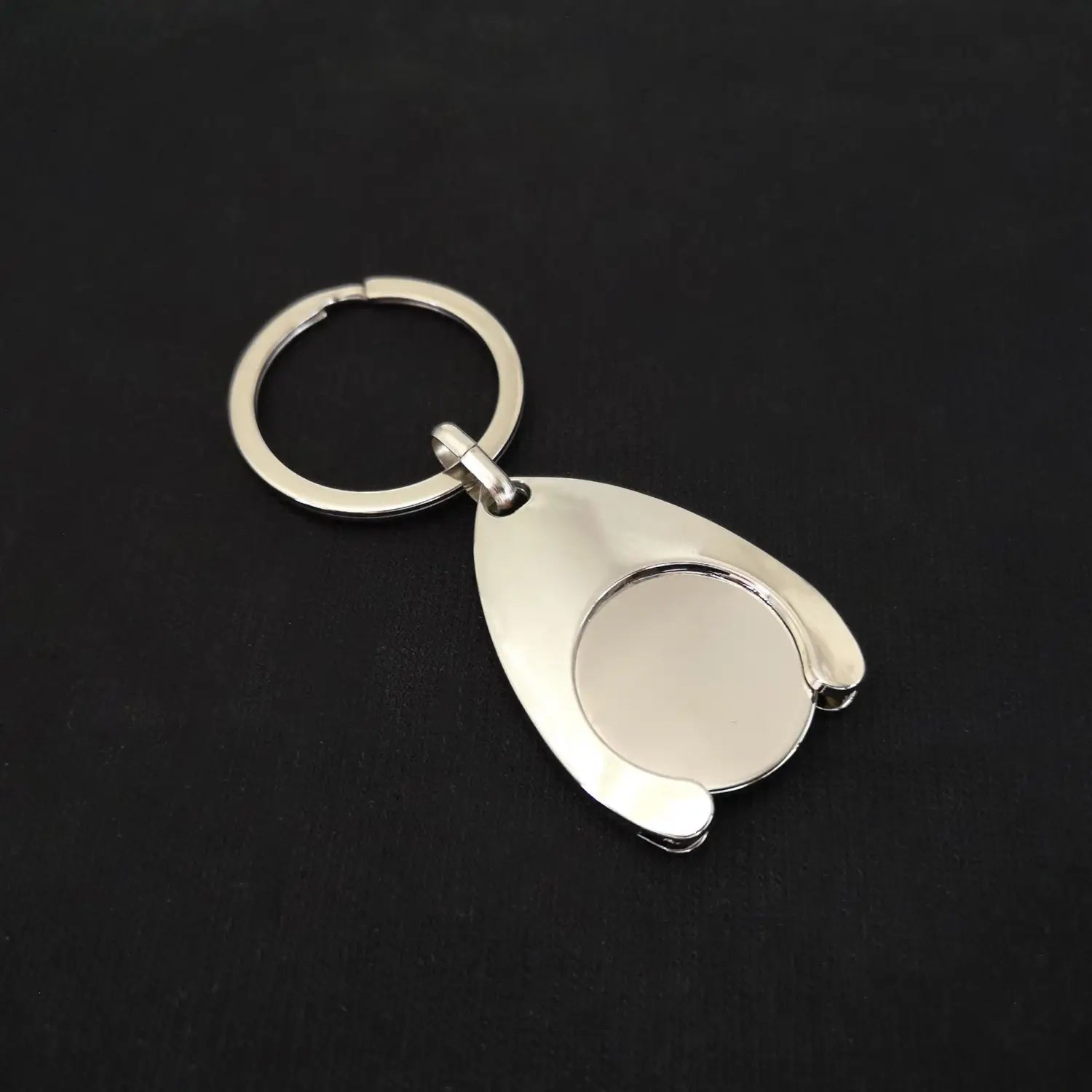Silver metallic custom engraved metal keychain with a teardrop-shaped pendant featuring a circular inset.