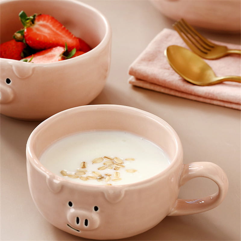 pink ceramic pig-shaped bowl filled with yogurt and oats from the cute pig ceramic dinnerware set