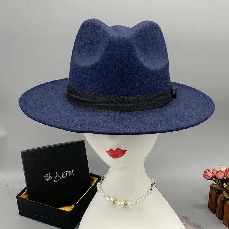 Deep blue unisex woolen felt fedora hat with black ribbon band and feather accent.