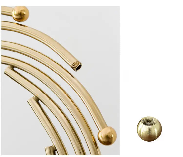 gold metal abstract sculpture featuring golden brass curved rods with spherical ball ends and threaded fittings designed as office desk decor.
