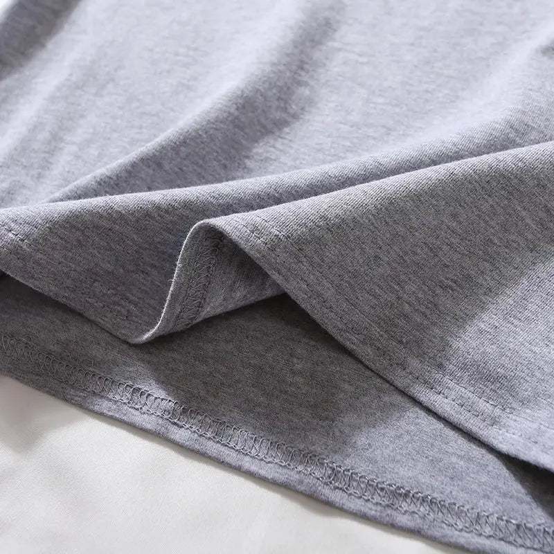 A soft heather gray cotton women solid short sleeve crop top casual t-shirt with neatly stitched hemming.
