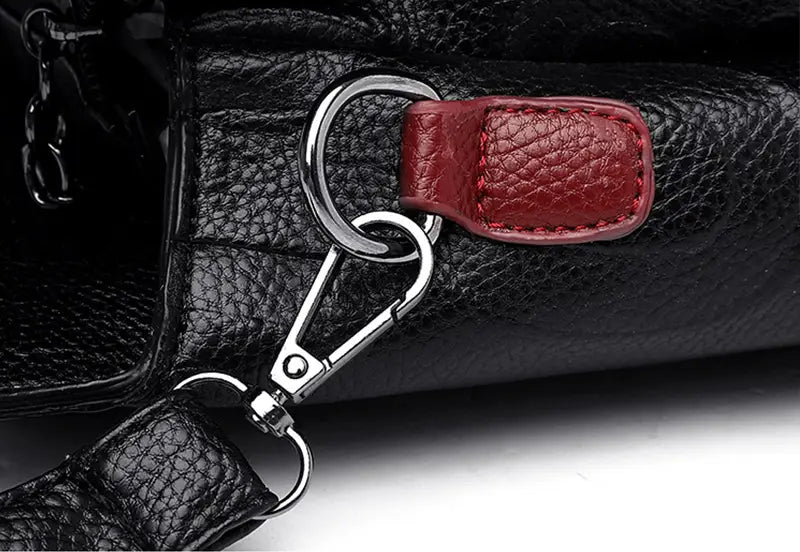 black crossbody handbag style1 style2 featuring a black textured leather strap with a red leather accent and silver toned metal clasp in pu leather satchel style1 style2 style1