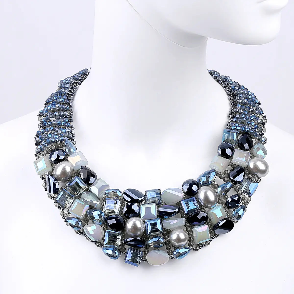 Crystal pearl statement choker necklace featuring layered strands of blue black and silver-toned crystals and pearls set in a dark metal framework.