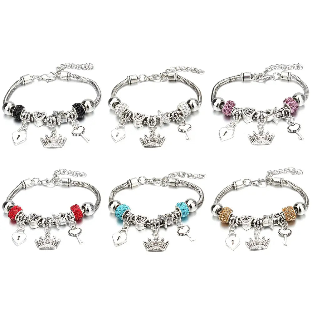 Six silver-toned charm bracelets with snake chain design featuring assorted beads and dangling crown charms as beaded bracelets for women.