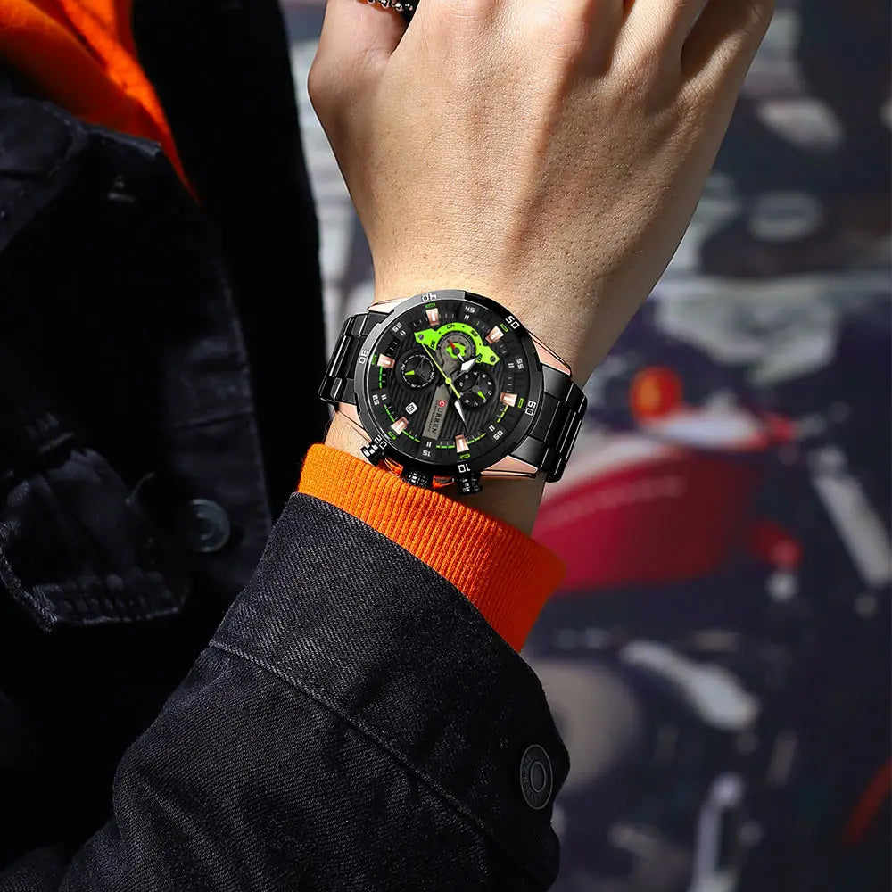 Curren men black green chronograph stainless steel watch with a metallic bracelet worn on a wrist.