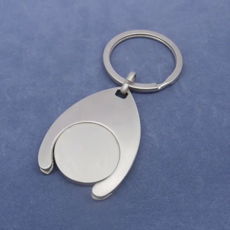 Custom engraved metal keychain featuring a silver metallic teardrop-shaped coin flipper design.