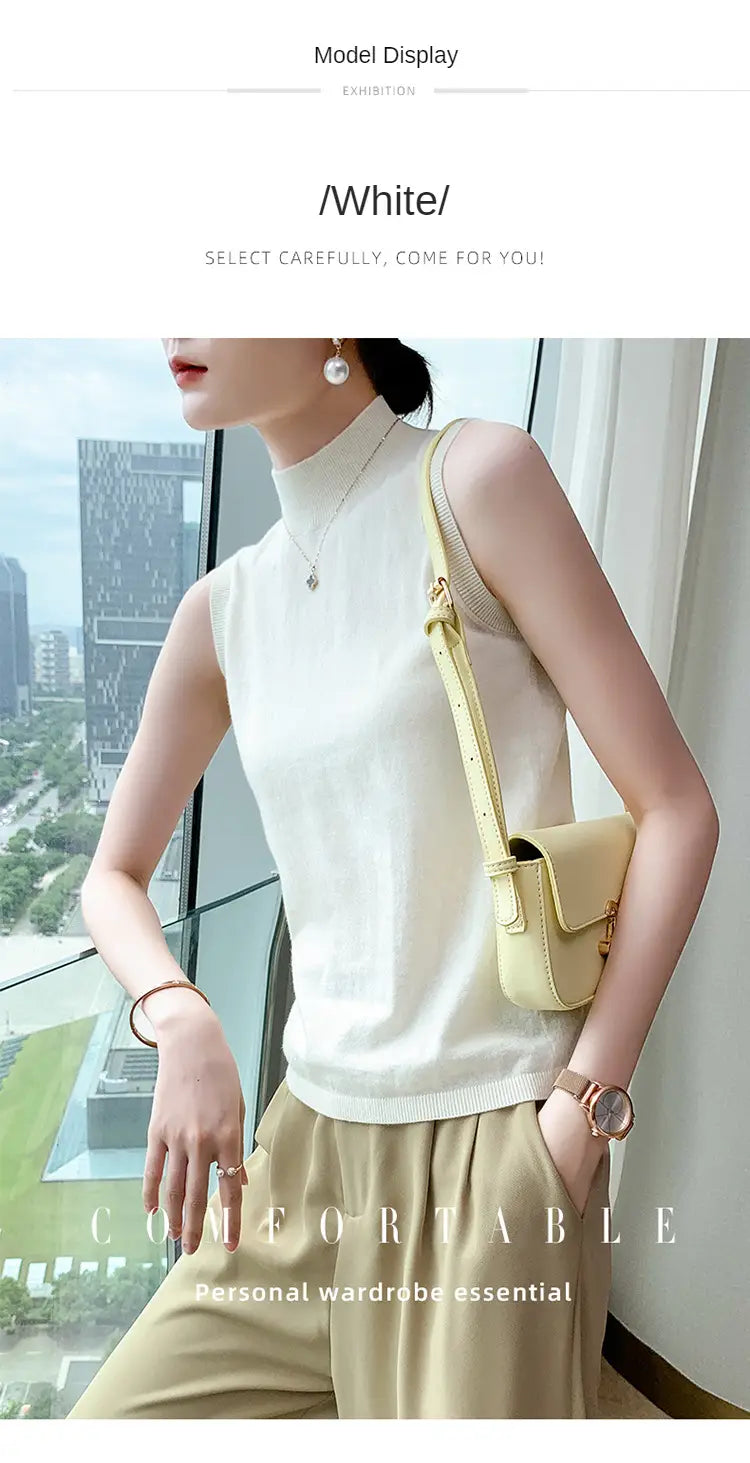 A soft white wool turtleneck sleeveless sweater vest with a high neckline and subtle ribbed detailing.