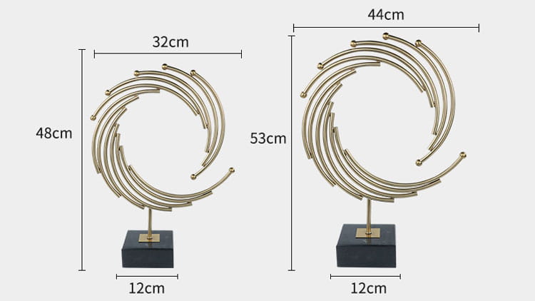 gold-toned spiral metal sculpture with a black marble base as an abstract office desk decor piece