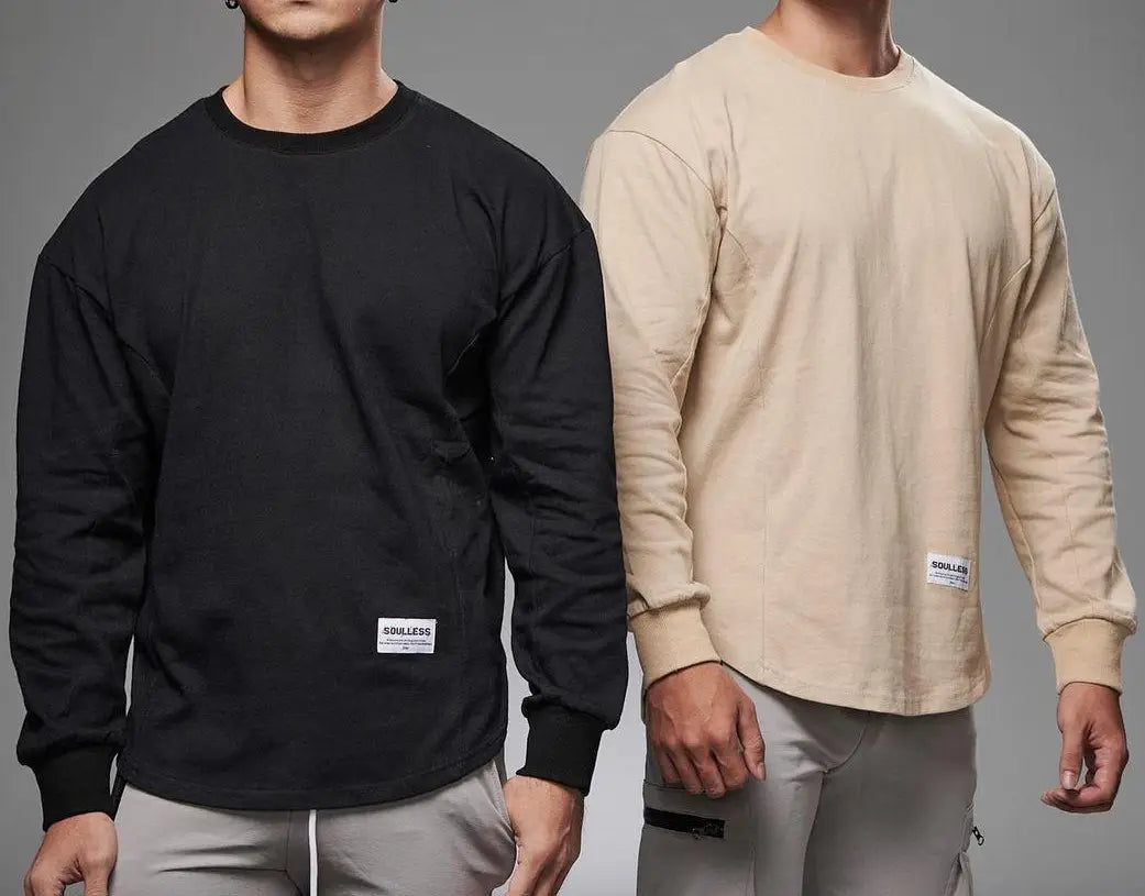 men long sleeve cotton t shirt in black and beige featuring a crewneck with ribbed cuffs and hem and a small white label at the bottom front