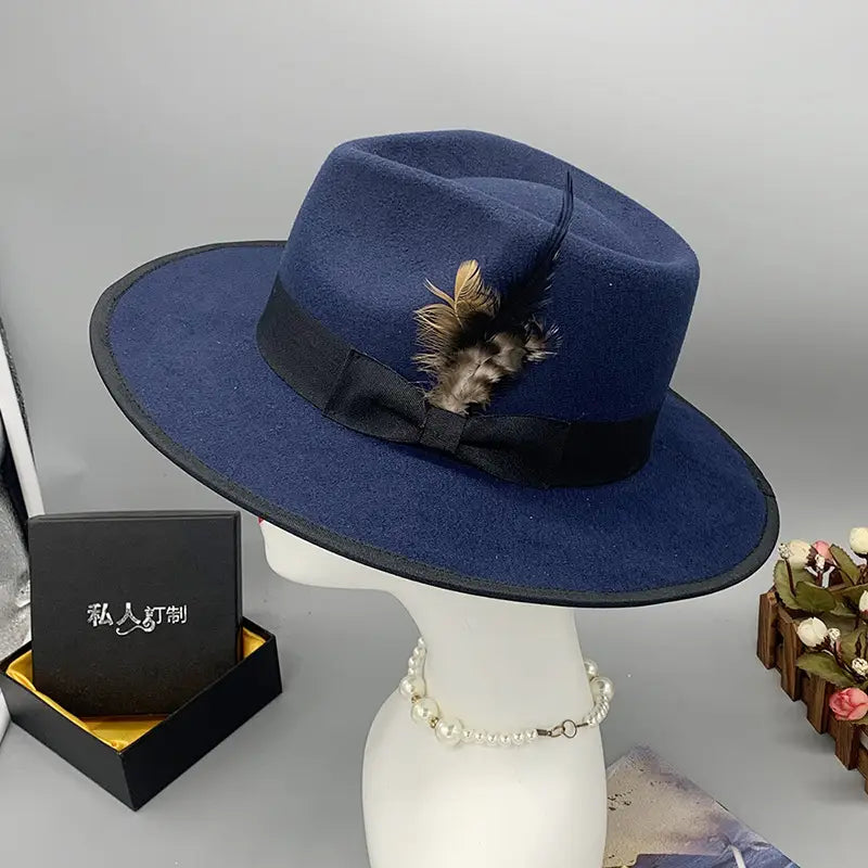 Deep blue unisex woolen felt fedora hat with a black ribbon bow and decorative feather accent.
