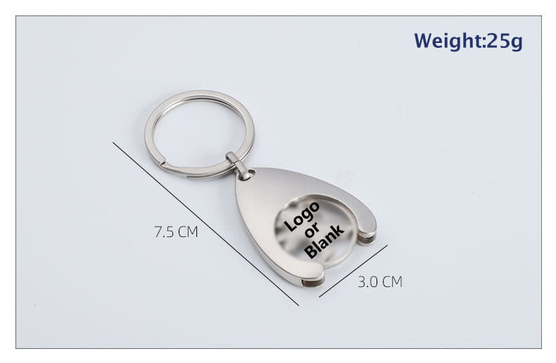 Silver metallic custom engraved metal keychain with a teardrop-shaped coin flipper design featuring an engraved logo or blank area for customization.
