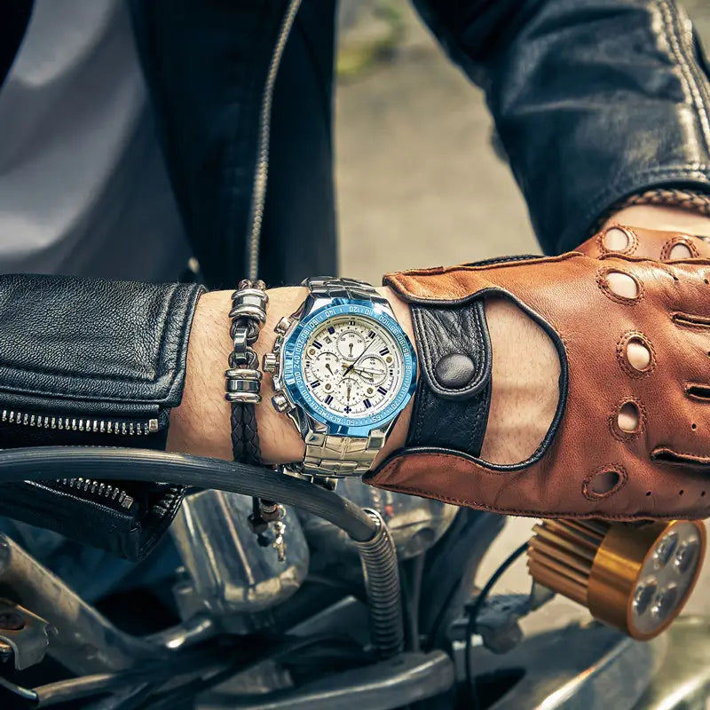Gold chronograph watch for men in stainless steel featuring a silver-toned case with a vibrant blue bezel and white dial with multiple subdials and black hour markers.