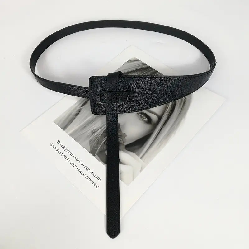 Women wide pu leather knot waist belt in black textured leather with a minimalist rectangular buckle and matching strap.